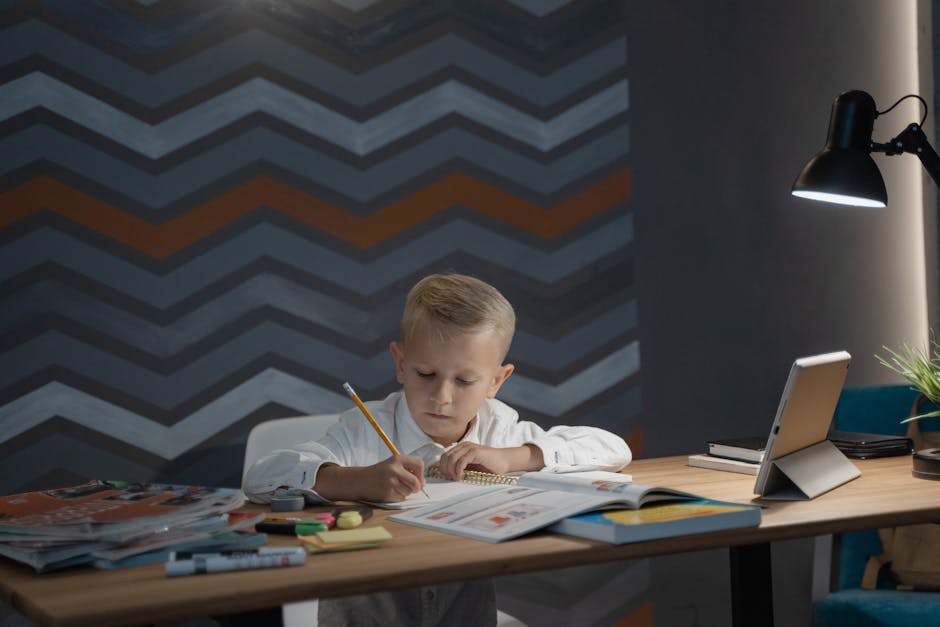 A child focuses on his homework at a desk with a tablet and lamp, promoting education at home