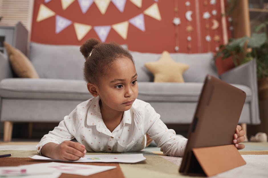 A young girl focused on learning online with a tablet in a cozy home setting.