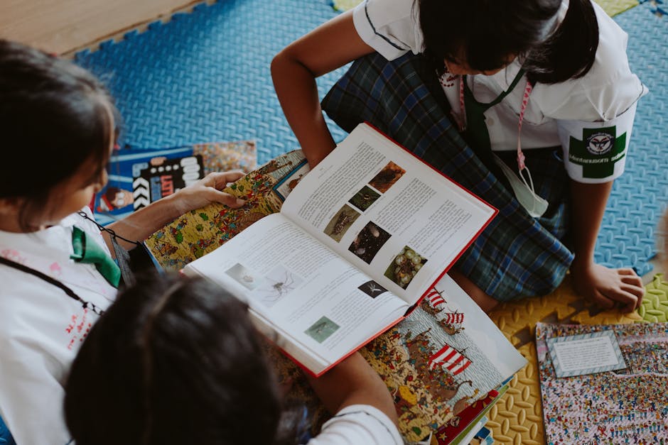 Three children actively reading books together in a school setting.